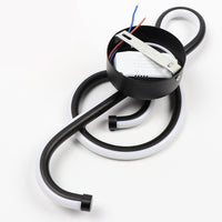 Electrical component with black cable and white base on a white background