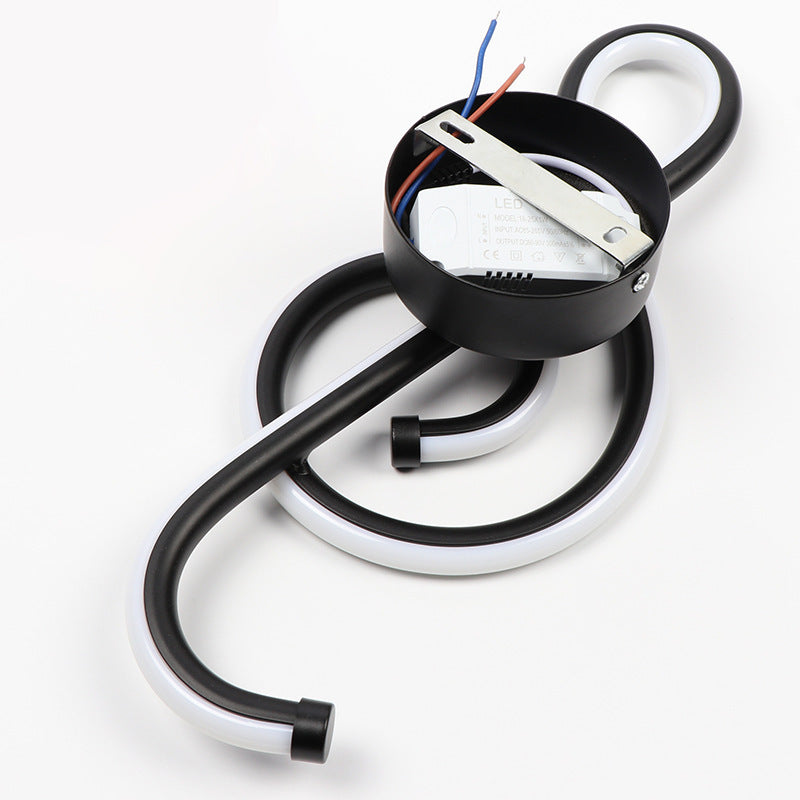 Electrical component with black cable and white base on a white background