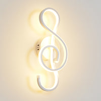 Wall lamp shaped like a treble clef on a light gray background