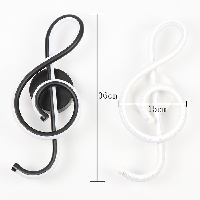 Black treble clef wall light fixture with measurements on a white background